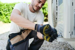 Is It Normal for My AC to Turn On and Off? - Technician Working Outside.